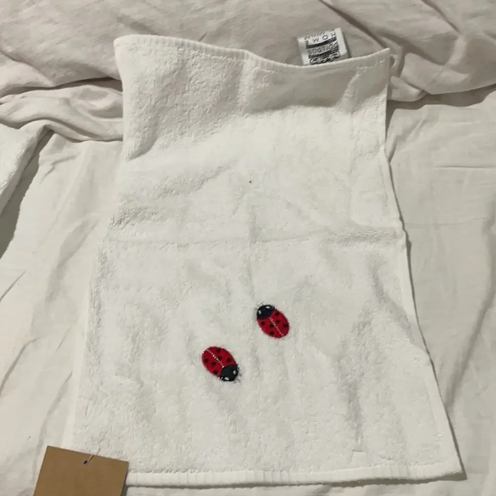 Priapos Home white hand towel with2 embroidered lady bugs NWT and super cute